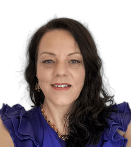 Psychic Tarot reader Maje Sodiz. This is a portrait picture wearing a smile and an indigo top. My wavy, dark hair is sitting on my left shoulder.